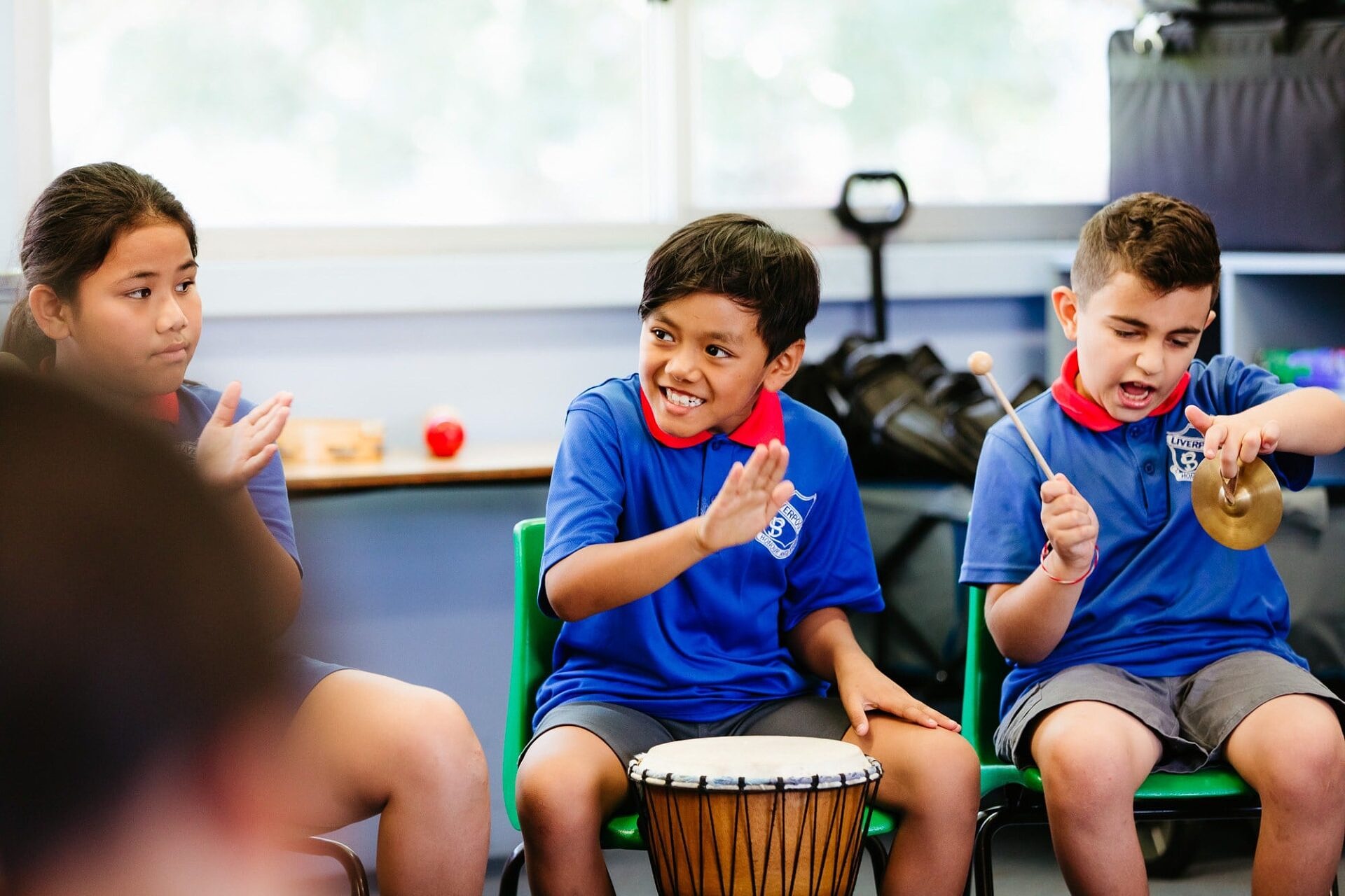 Students in the classroom playing percussion instruments.