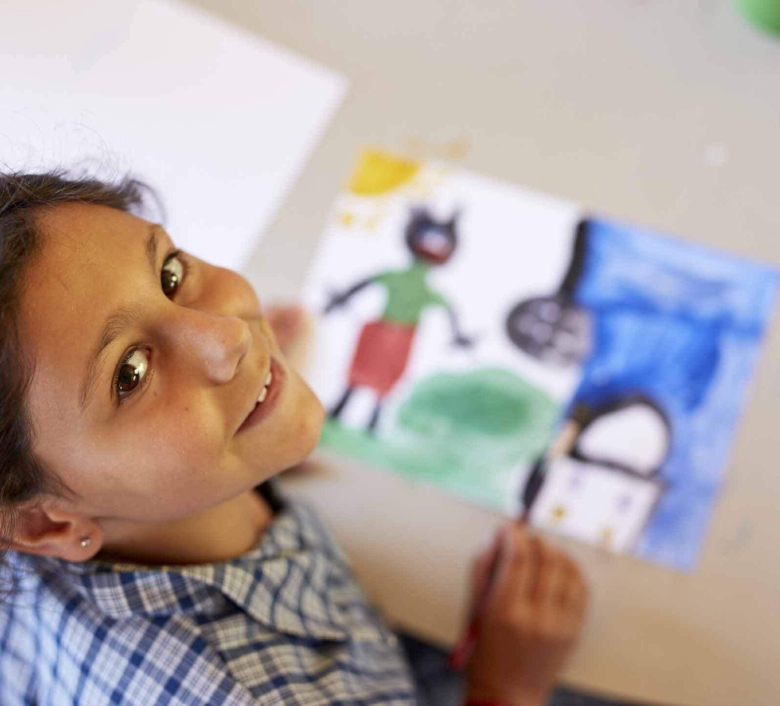 primary school student with her drawing in arts learning visual arts lesson