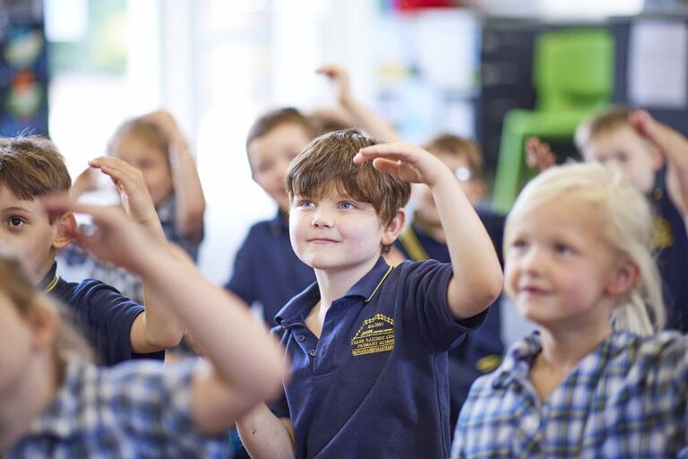 Primary school students dancing together in the classroom with The Song Room.