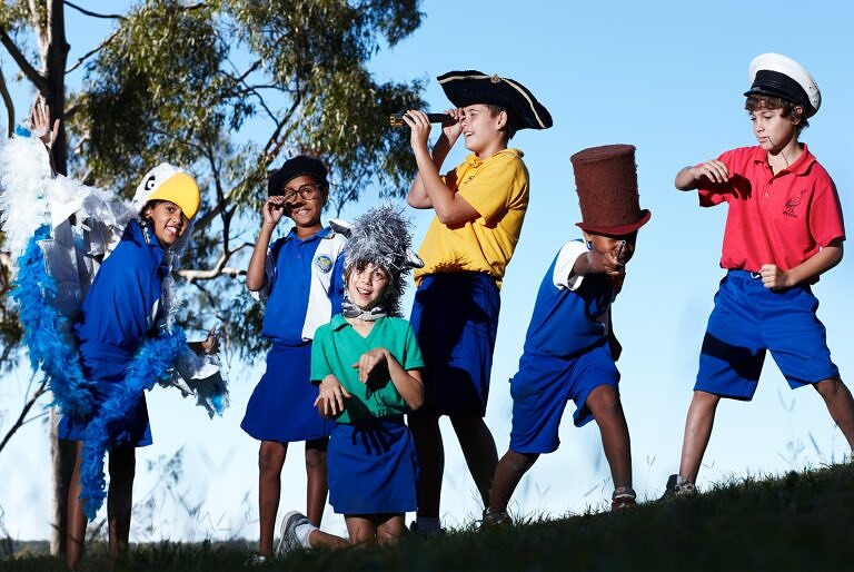 primary school students engaging in outdoor arts learning drama lesson in costumes