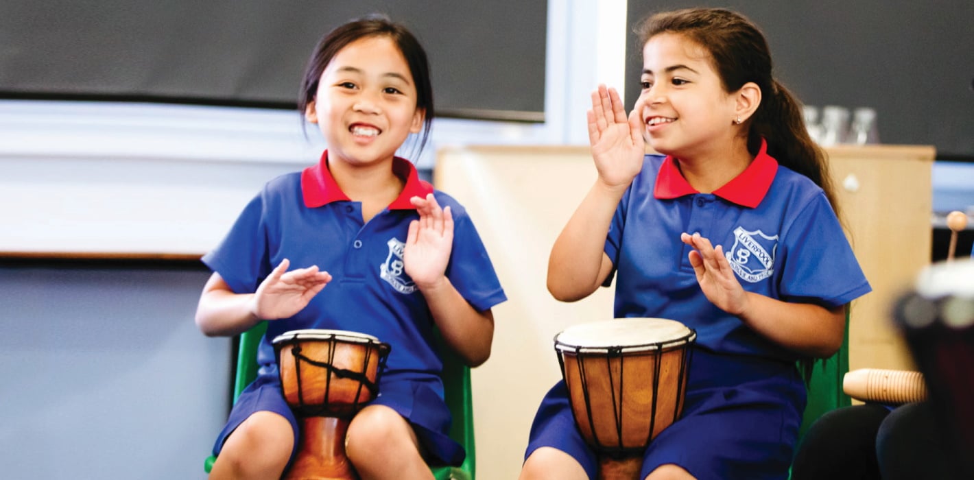 two primary school students an arts learning music lesson in African drums