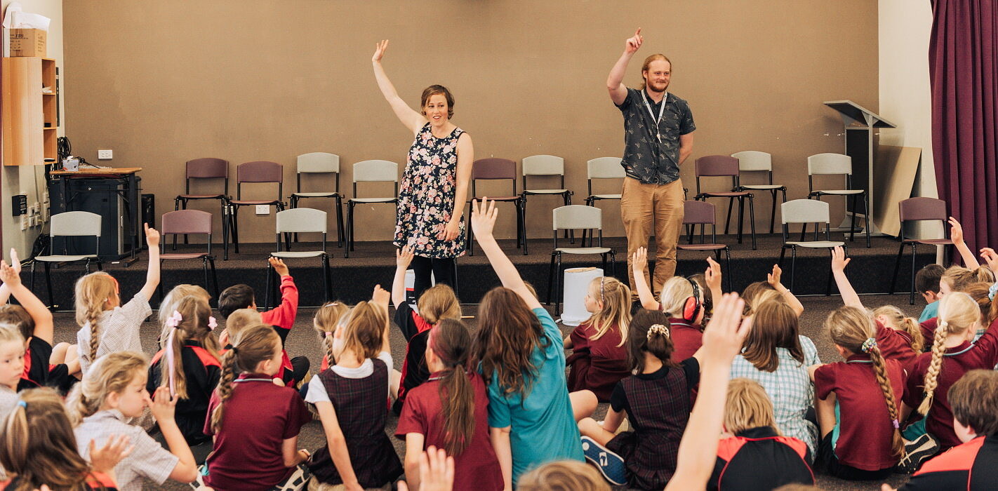 Teaching artists facilitating arts education lesson for primary school students