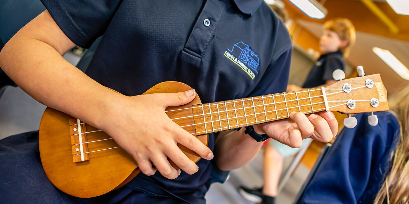 Primary school student playing ukulele in arts learning music lesson in one of Song Room programs