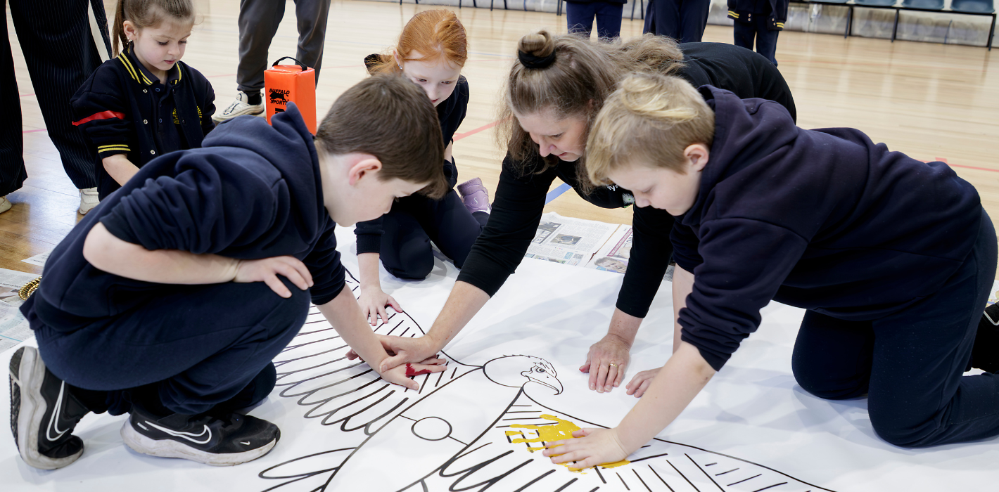 Kulin Artist and First Nations Arts Educator Aunty Sammy Trist (Taungurung) painting with students on Bunurong Country. Through The Song Room’s Deadly Arts programme, students engage in place-based learning that fosters a deep connection to Country and cultural identity through the arts.