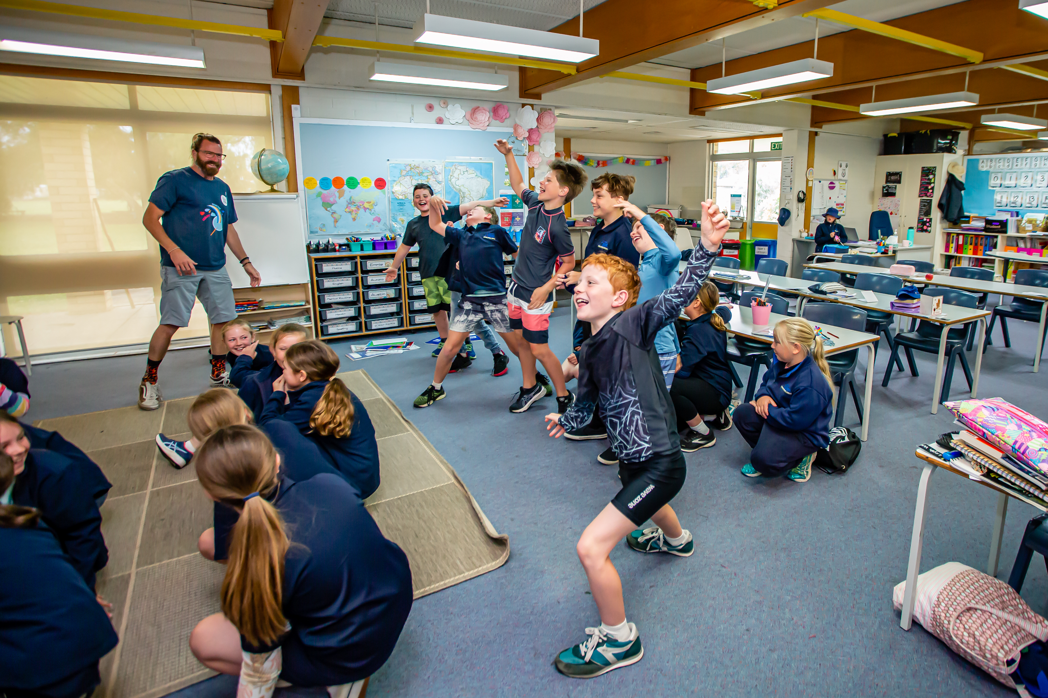A Song Room Teaching Artist leading a large group of students in a rhythmic clapping activity at Millipalooza.
